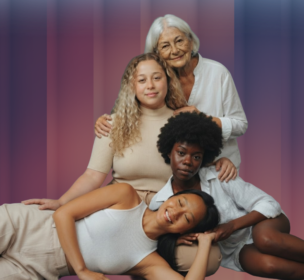 Four women of different ages and backgrounds posed together in a warm, supportive group