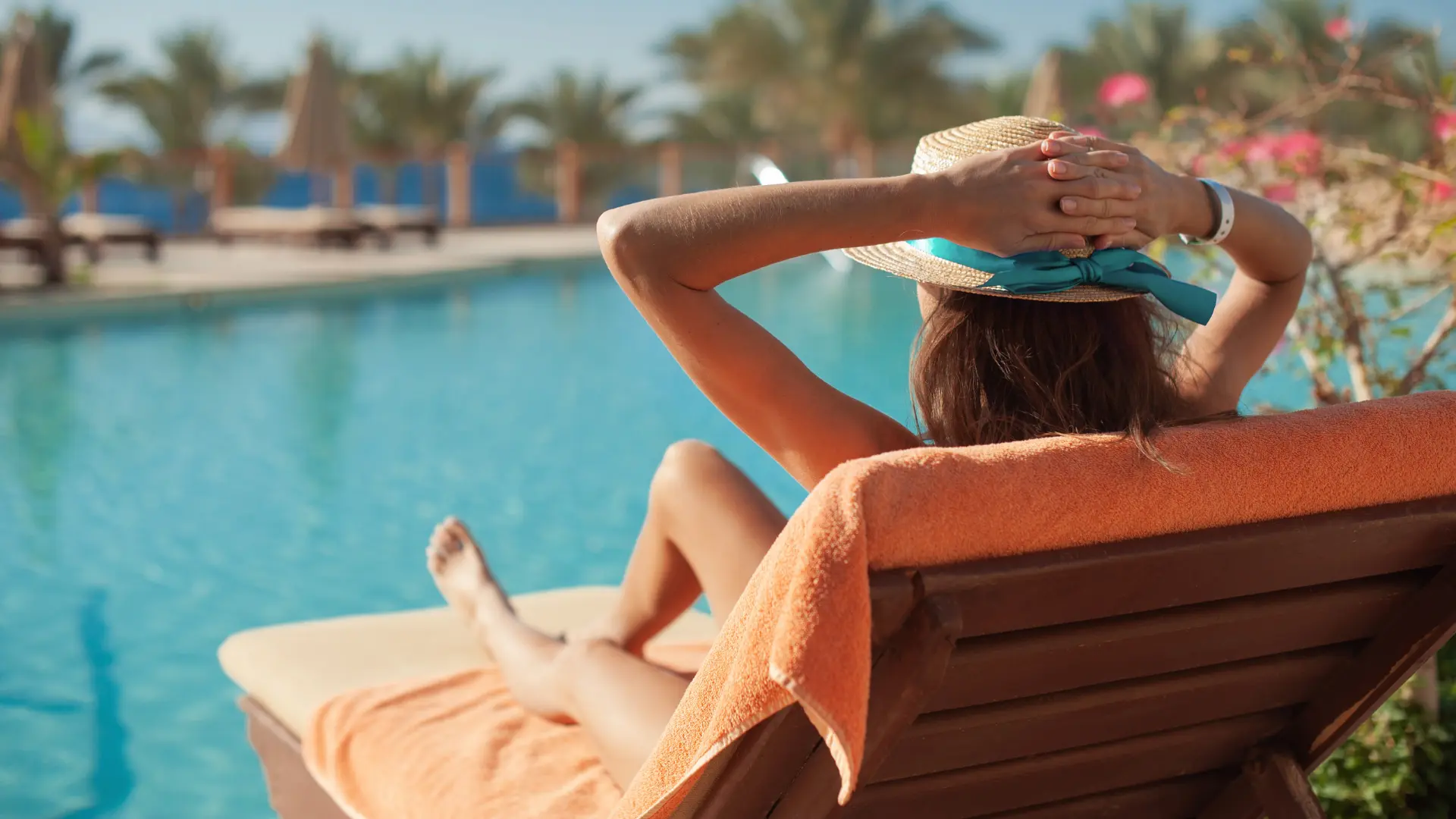 Woman resting poolside in the sun